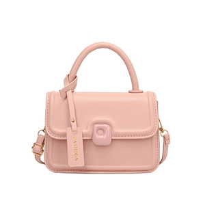 Pink matte leather crossbody bag with top handle and gold hardware in minimalist style