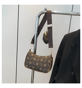 Detail of hobo shoulder bag with monogram print, wide strap and small round coin purse