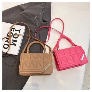 Detail of caramel brown and magenta crossbody bags with quilted pattern and woven handles
