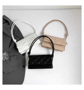 Detailed overhead view of quilted geometric crossbody bags in black, beige, and white