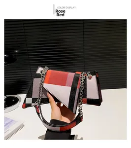 Detail of rose red geometric patchwork shoulder bag with silver metal chain strap