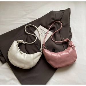 Minimalist crescent shoulder bags in cream and dusty rose with knotted strap detail
