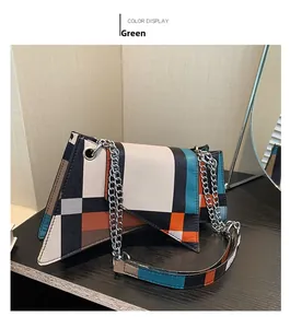 Detail of color-block geometric leather bag with green flap and silver chain strap
