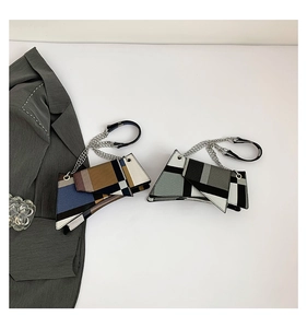 Detail of color-block geometric shoulder bags with silver chain and leather straps