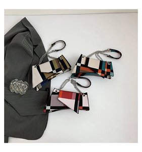 Detailed view of geometric patchwork handbags with grain texture and silver chain straps