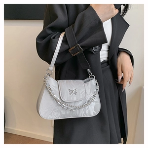Detail view of silver marble textured underarm bag with metal butterfly buckle and chain