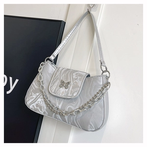 Detailed view of silver marble textured underarm bag with hollow butterfly metal hardware
