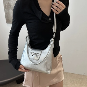 Silver metallic shoulder bag with bow decoration and adjustable strap for women