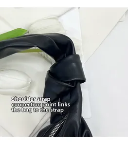 Detailaufnahme des geknoteten Schultergurts und Reißverschlusses der schwarzen Hobo-Bag