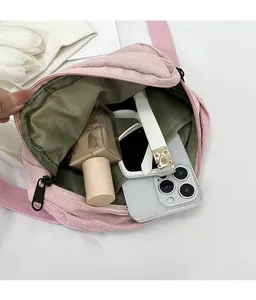 Interior detail of pink quilted bag with green lining showing spacious storage space