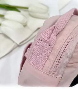 Detail shot of reinforced stitching and pink checkered tear-resistant fabric texture
