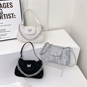 Three elegant underarm bags with marble texture, butterfly buckles and silver chain straps