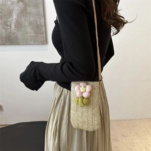 Summer woven straw crossbody phone bag with cute smiling floral detail and slim strap