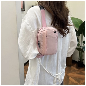Pink nylon crossbody bag with multi-layer zipper pockets and adjustable strap for women