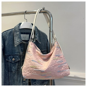 Détail du sac hobo rose avec broderie texturée 3D géométrique et bandoulière blanche