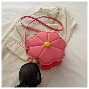 Detail of pink flower shaped leather bag with yellow button and matching shoulder strap
