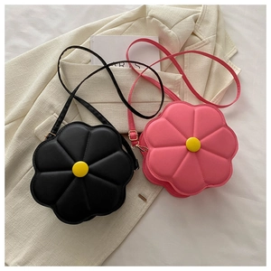Close-up of pink and black flower-shaped crossbody bags with 3D quilted texture