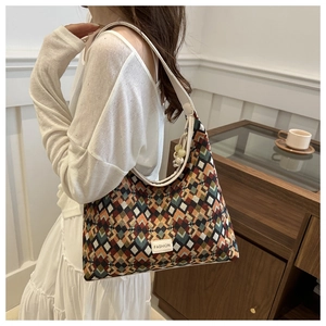 Detailed close-up of a colorful geometric pattern tote bag with retro quilted fabric texture