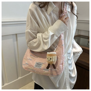 Detail of pink pleated crossbody bag with rainbow embroidery and cupcake plush charm