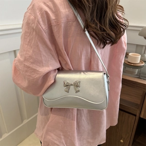 Fashionable silver PU leather shoulder bag with metallic bow and wavy flap design