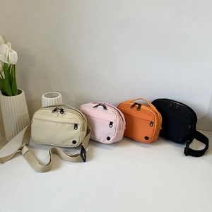 Minimalist nylon crossbody bag in four colors with adjustable strap and zip pockets