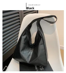 Detail of black large capacity tote bag featuring a modern geometric patchwork design