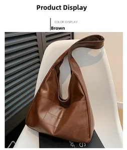 Detailed view of a brown patchwork tote bag hanging on a white chair in a studio