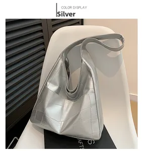 Detail view of silver metallic large tote bag with patchwork geometric faux leather texture