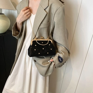 Elegant black velvet handbag with gold heart studs and vintage metal top handle