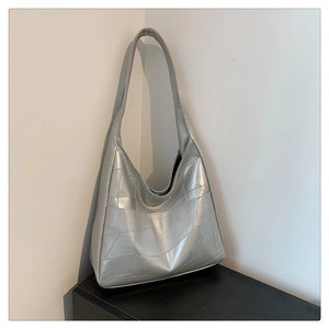 Close-up of silver Hobo bag featuring modern geometric stitching and metallic finish