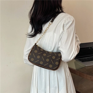 Vintage dark brown crossbody bag with floral monogram print and golden chain strap