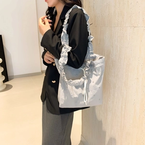 Light gray drawstring tote bag with rhinestone embellishments and ruffled shoulder straps
