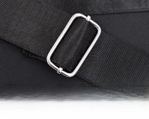 Close-up of black adjustable nylon shoulder strap with a silver metal rectangular buckle