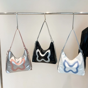 Three minimalist tote bags with oversized butterfly patches and chain straps