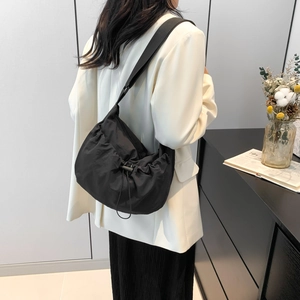 Minimalist black nylon drawstring shoulder bag with a cloud-shaped slouchy design for women