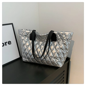 Silver quilted tote bag featuring metallic finish and spacious interior for daily use