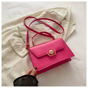 Detail of rose red small square bag with gold ring lock and textured PU leather