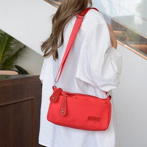 Water-resistant red nylon shoulder bag for women with adjustable strap for casual wear