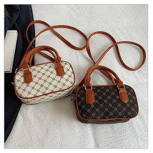 Detailed view of two mini Boston bags in beige and brown with geometric vintage prints