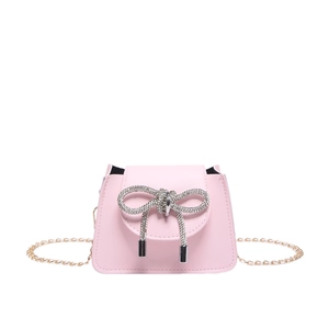 Pink leather mini crossbody bag with gold chain strap and sparkling rhinestone bow