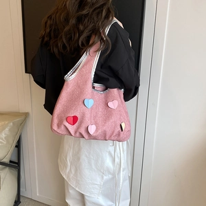 Pink textured felt tote bag with colorful heart patches and metallic silver trim