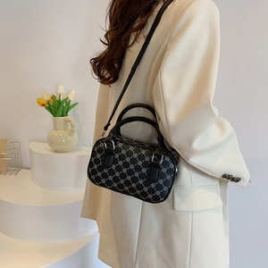 Chic black Boston handbag with white chain pattern and adjustable shoulder strap