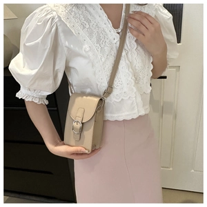 Chic beige crossbody phone bag shown on a model with an adjustable shoulder strap