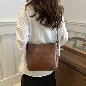 Retro brown PU leather tote bag with adjustable strap shown on model for daily commute