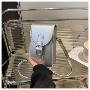 Close-up of a silver metallic crossbody phone bag with polished faux leather and buckle detail