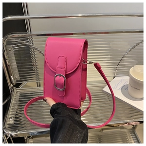 Handheld magenta synthetic leather phone bag with adjustable strap and metal buckle detail