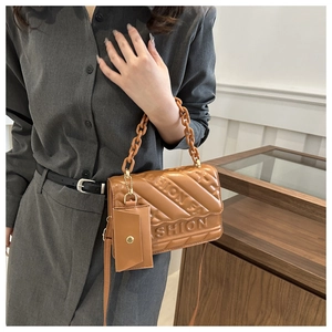 Detail of tan quilted crossbody bag with FASHION lettering and mini coin purse