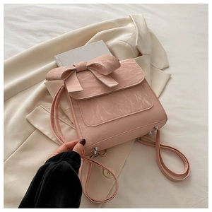 Macro detail of pink butterfly backpack with marble texture and metal bottom studs