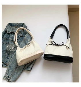 Detailed view of canvas tote bags featuring stylish bow drawstring and contrast color design
