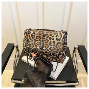 Detail shot of leopard print shoulder bag with black metal rivet lock and chain strap